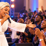 Female gospel singer connecting with a congregation during a live worship performance